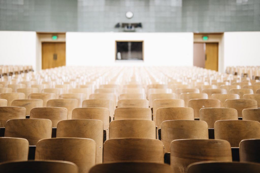 a large, empty auditorium with lots of wooden chairs