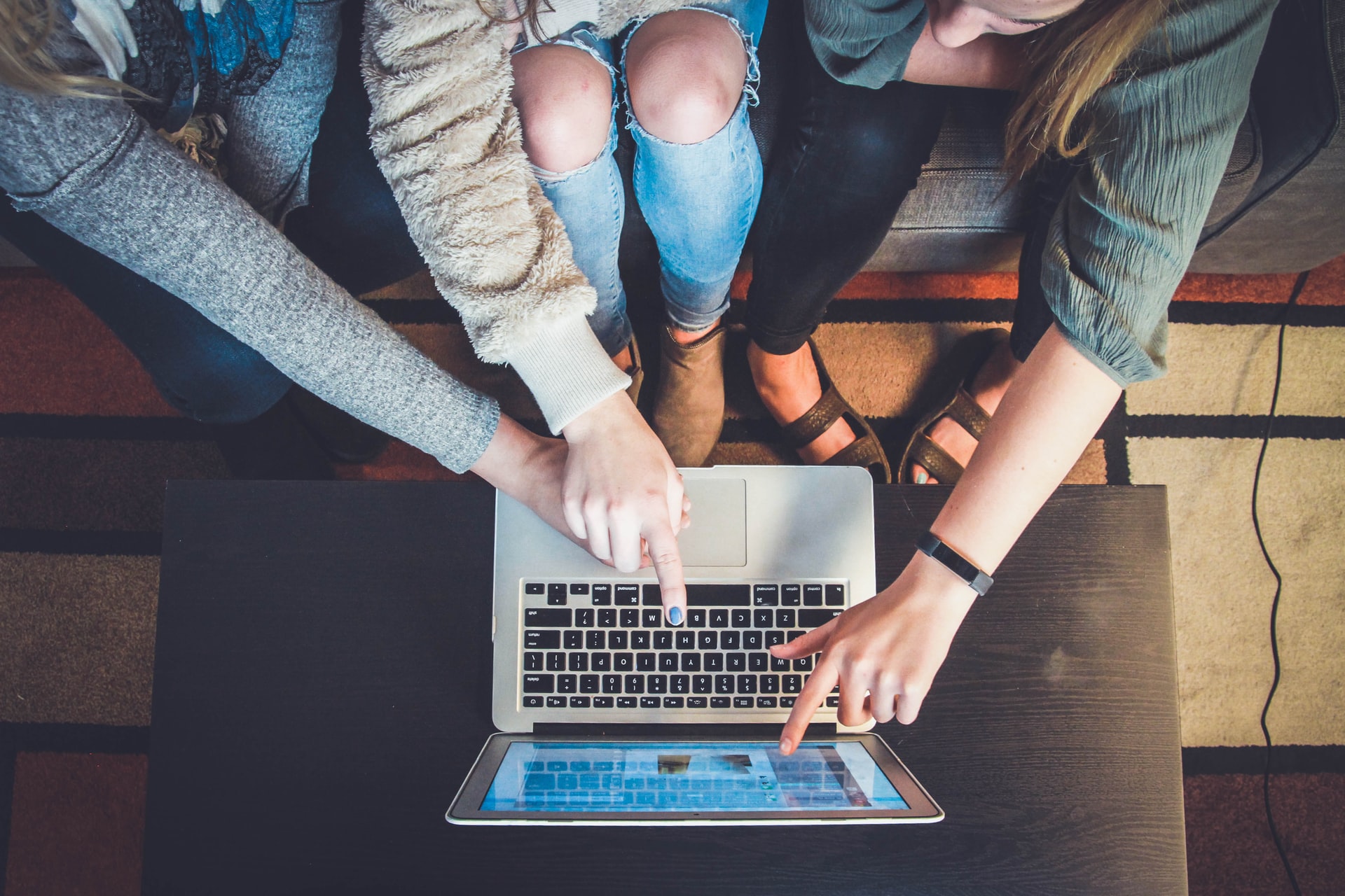 Two people using a laptop together