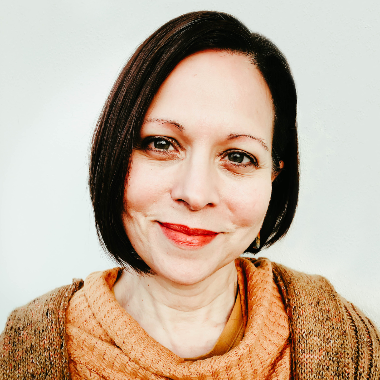 Pressbooks team member Julie Curtis wearing an orange sweater