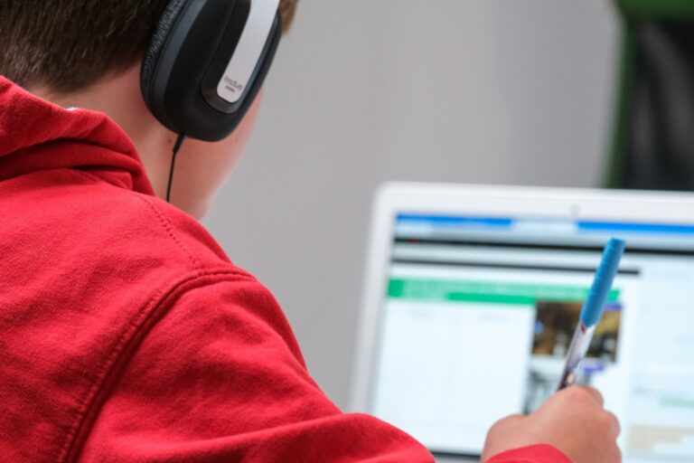Student on laptop with headphones