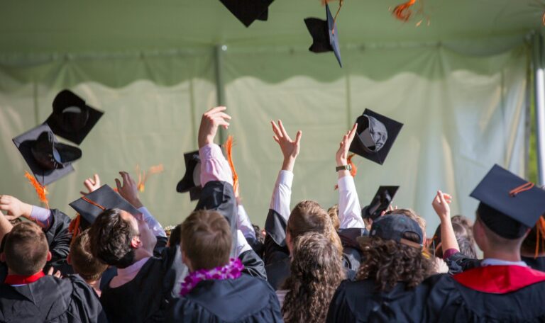 Students graduating college and throwing their caps in the air