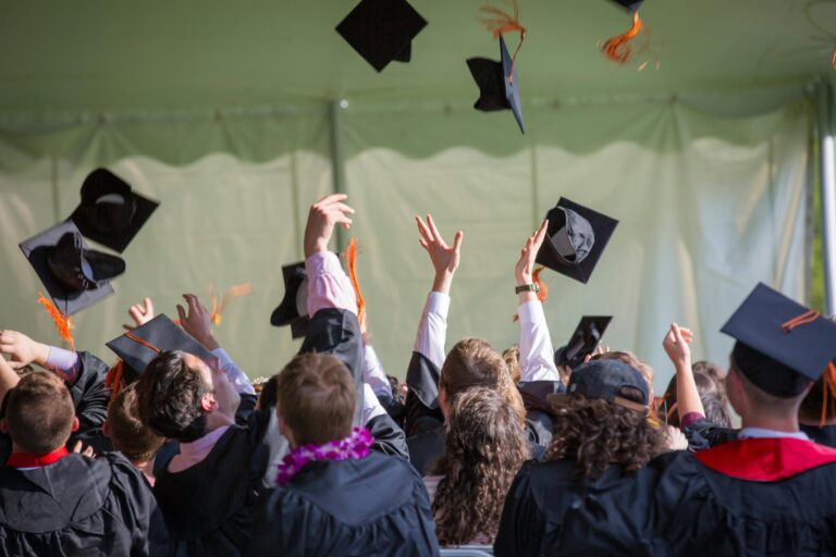 Students graduating college and throwing their caps in the air