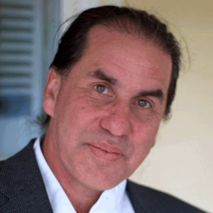Picture of a man with black hair wearing black suit and white shirt